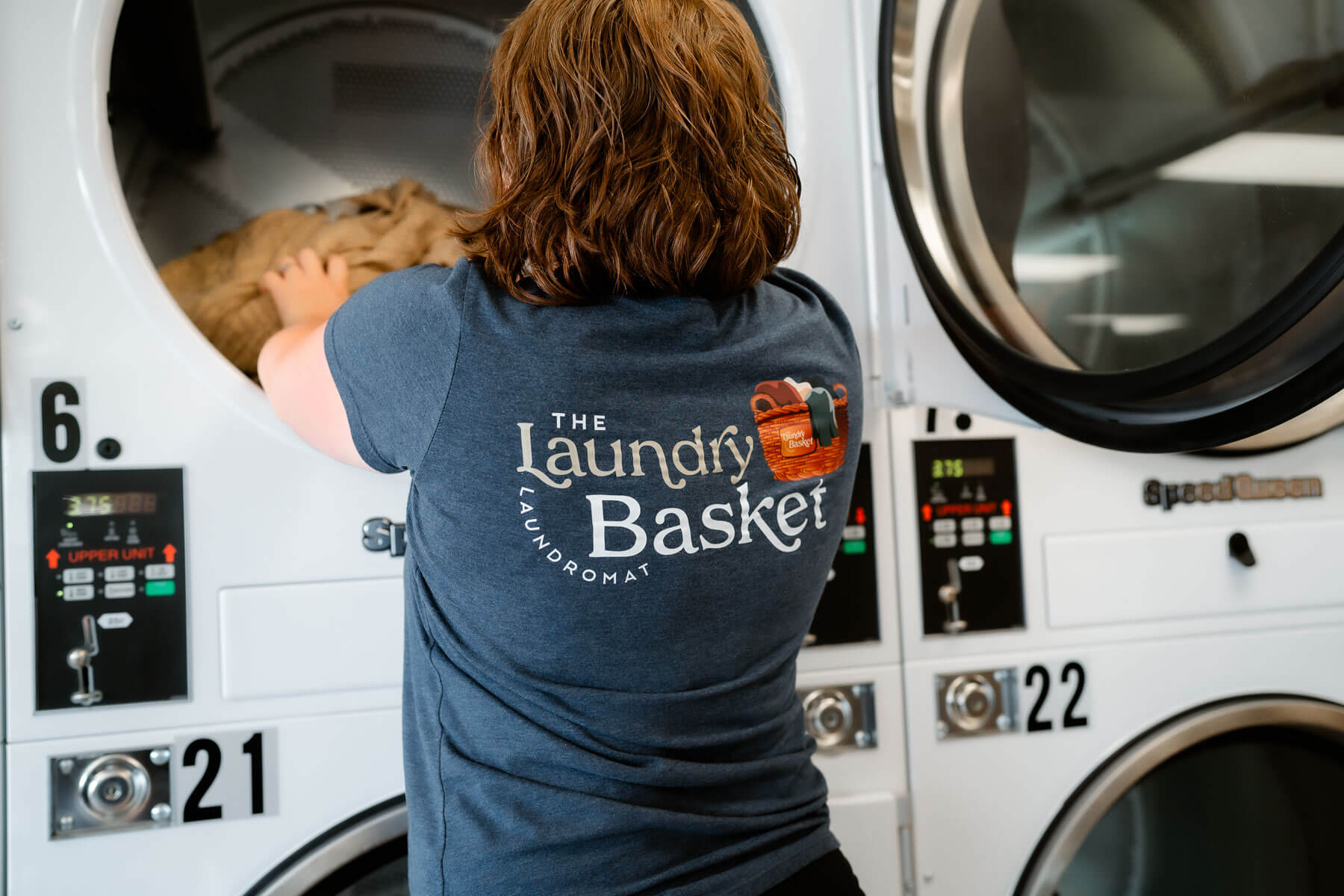 Woman Putting Clothes In Machine